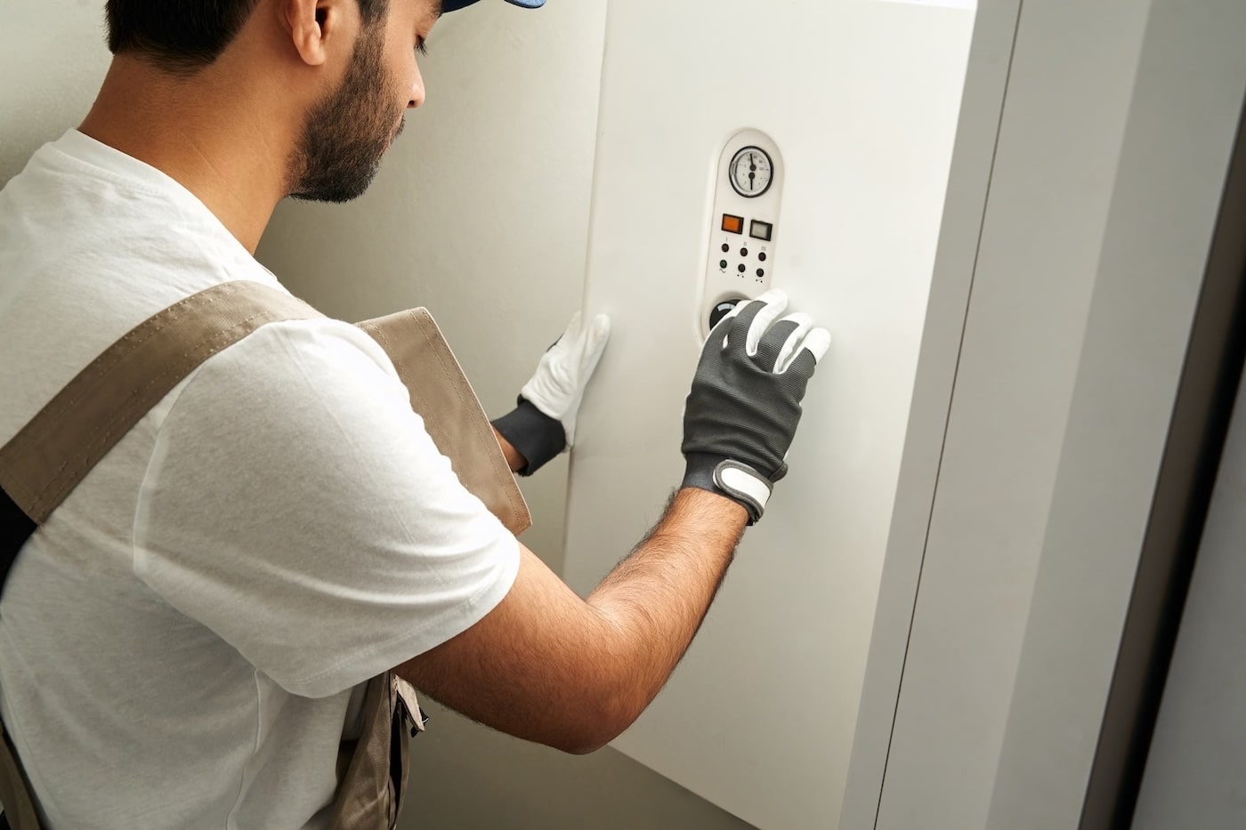 61779048 Professional Male Handyman In Uniform Is Checking Gas Boiler Working At Home Min